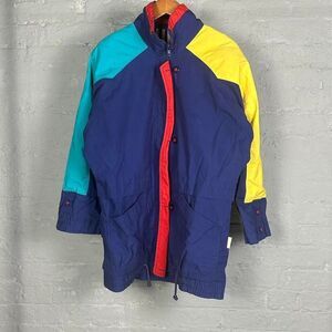 Blue and yellow Izzi retro ski jacket with multiple pockets and zipper details